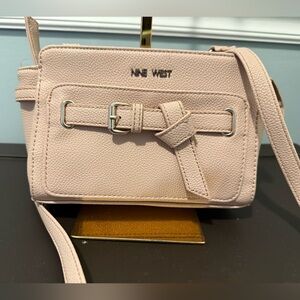 Nine West mini crossbody bag in a light pink/nude color with a buckle accent EUC
